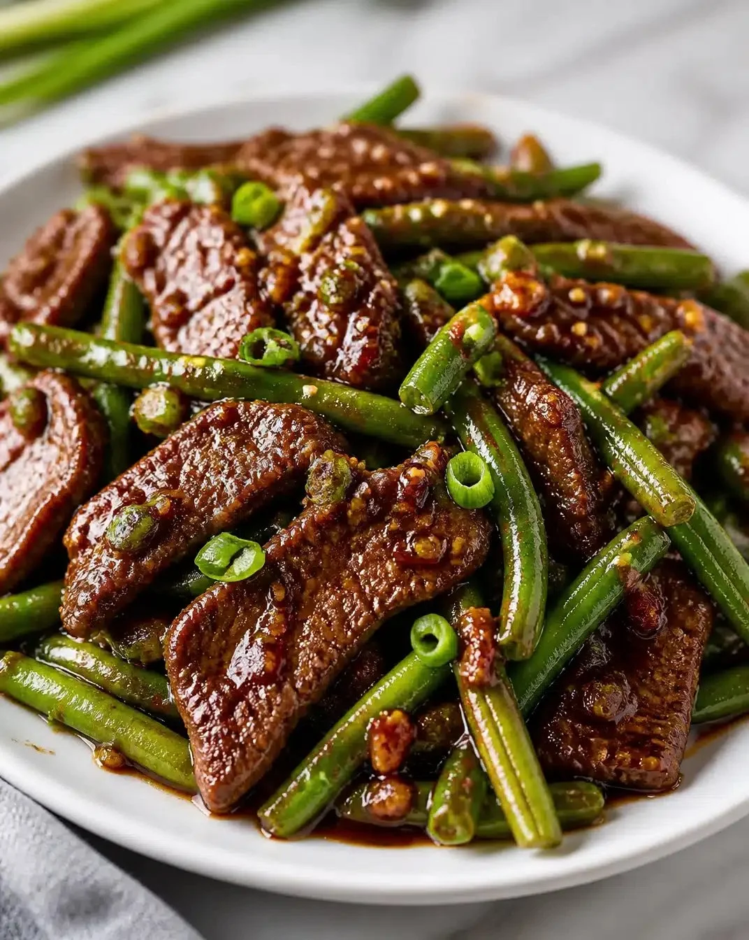 Garlic beef stir-fry with green beans on a Blackstone griddle.
