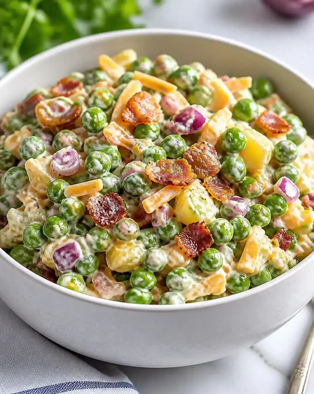 Traditional English Pea Salad with fresh peas, onions, and a creamy dressing